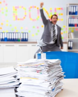 Man and a stack of papers